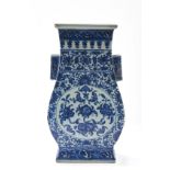 Vase quadrangulaire à anse, latéral à l’épaule ment, en porcelaine blanche, décoré en bleu cobalt de