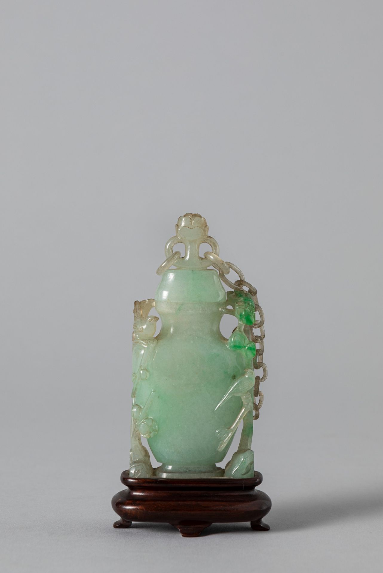 An apple green jadeite vase with cover. China, late Qing dynasty