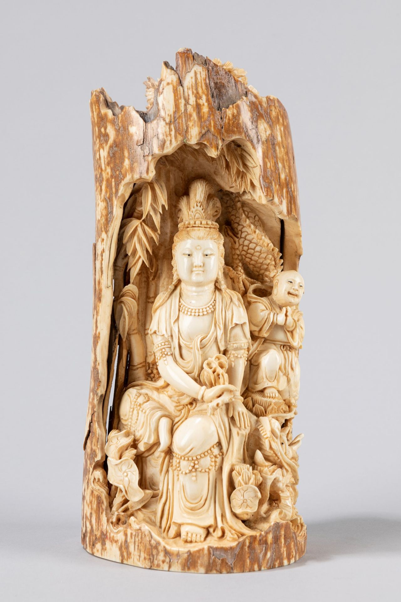 A Chinese mammoth fossil tusk carving of a Guanyin, the carving 19th century
