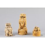 *Two ivory pho dogs and an ivory seal. China, late 19th century/early 20th century
