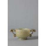 A celadon jade two-handled cup. China, late 19th century