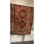 Persian rug of reds and fawns