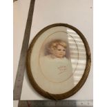 Watercolour in oval frame depicting a young child Signed Em Patterson July 1925