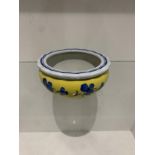 Yellow and white decorative bowl with blue flowers painted on