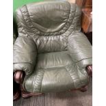 Green leather sofa with wooden arm rest