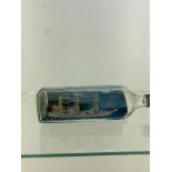 Glass bottle with ship inside