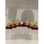 6 Resin Buddha figurines on small wooden plinth