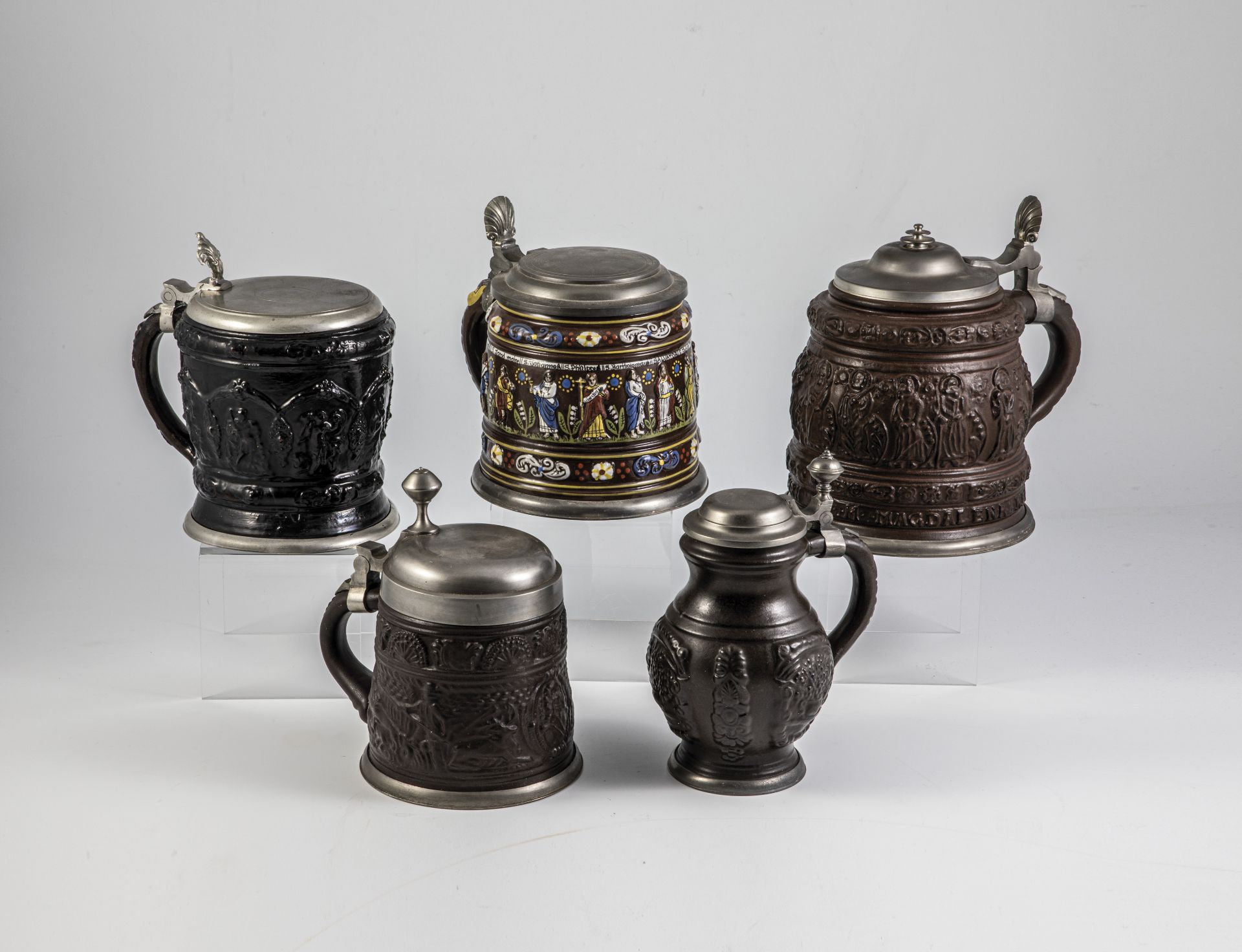 Five jugs with relief overlays