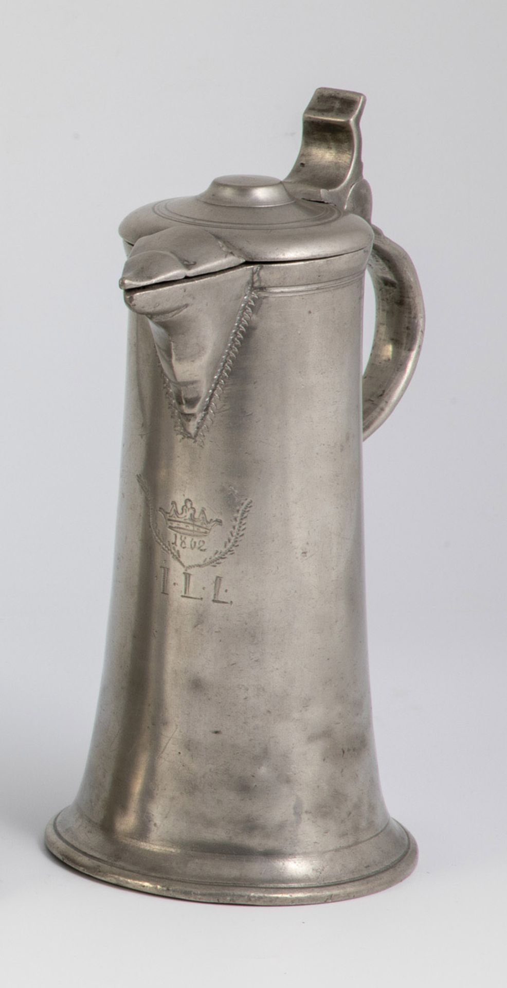 Slender pewter jug with beak spout