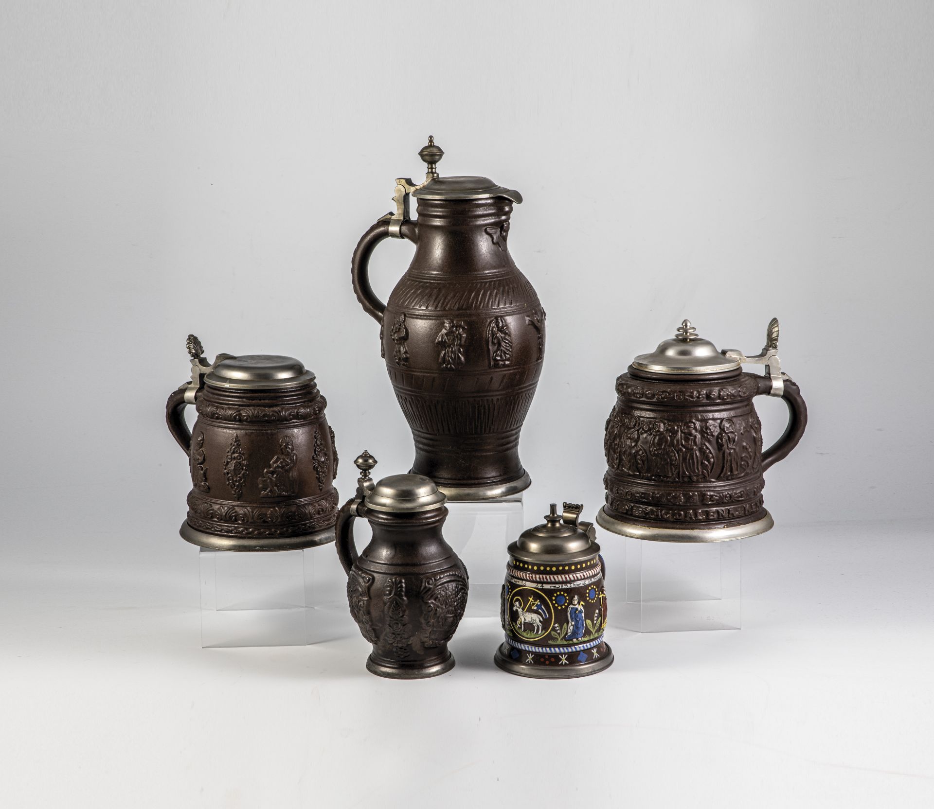 Three jugs and one apothecary bottle with relief overlays