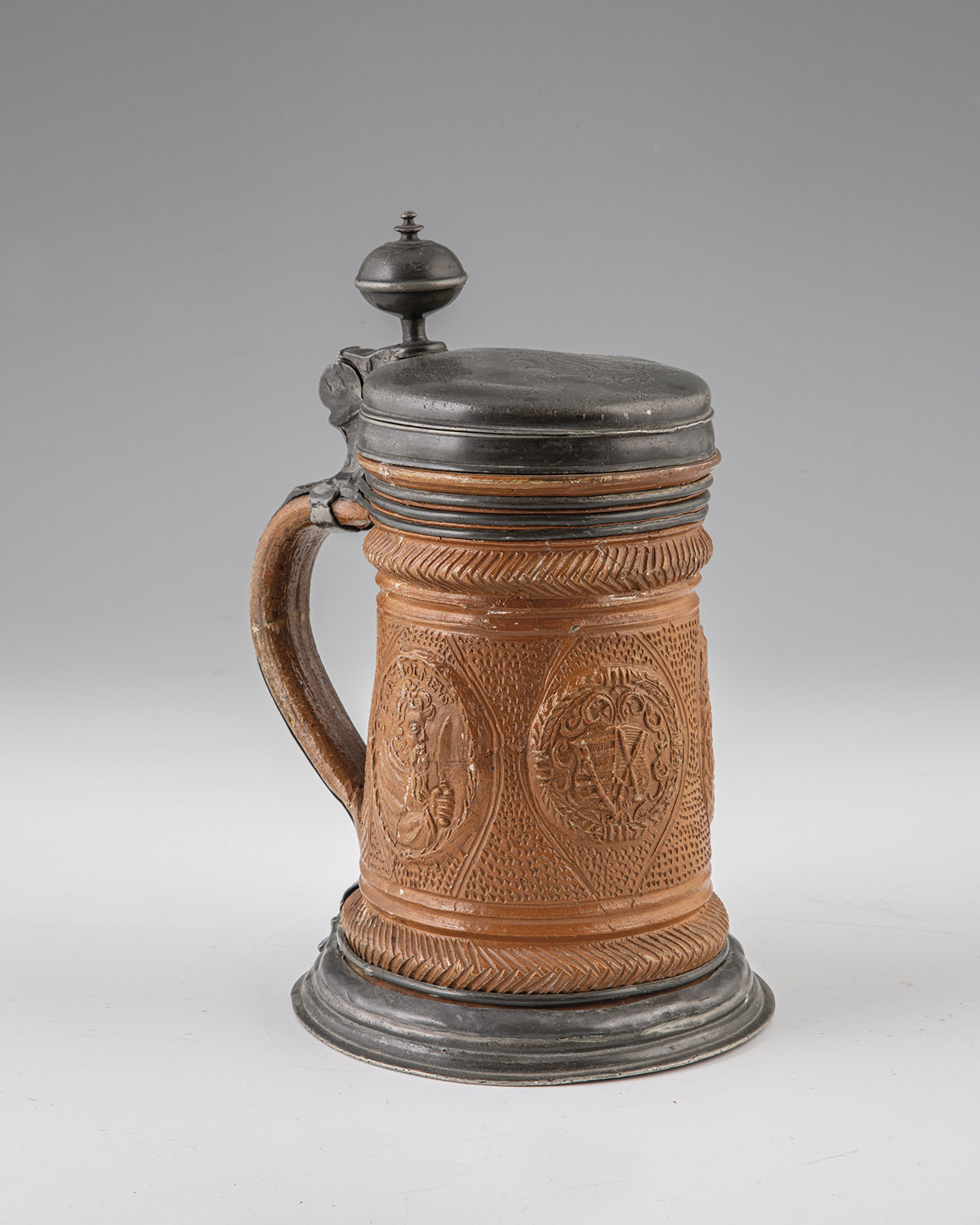 Roller pitcher with pewter mount