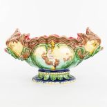 A cache-pot flower pot made of glazed faience in art nouveau style and decorated with putti and fish