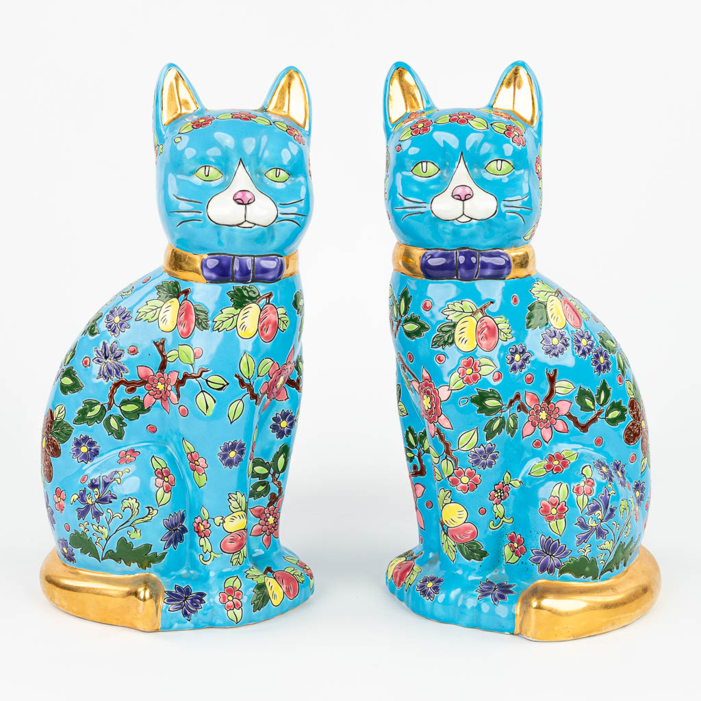 A pair of decorative cats made of glazed faience in the style of 'Emaux de Longwy'. (H:36cm)