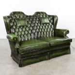 A green leather armchair with high back made in Chesterfield style. (H:107cm)