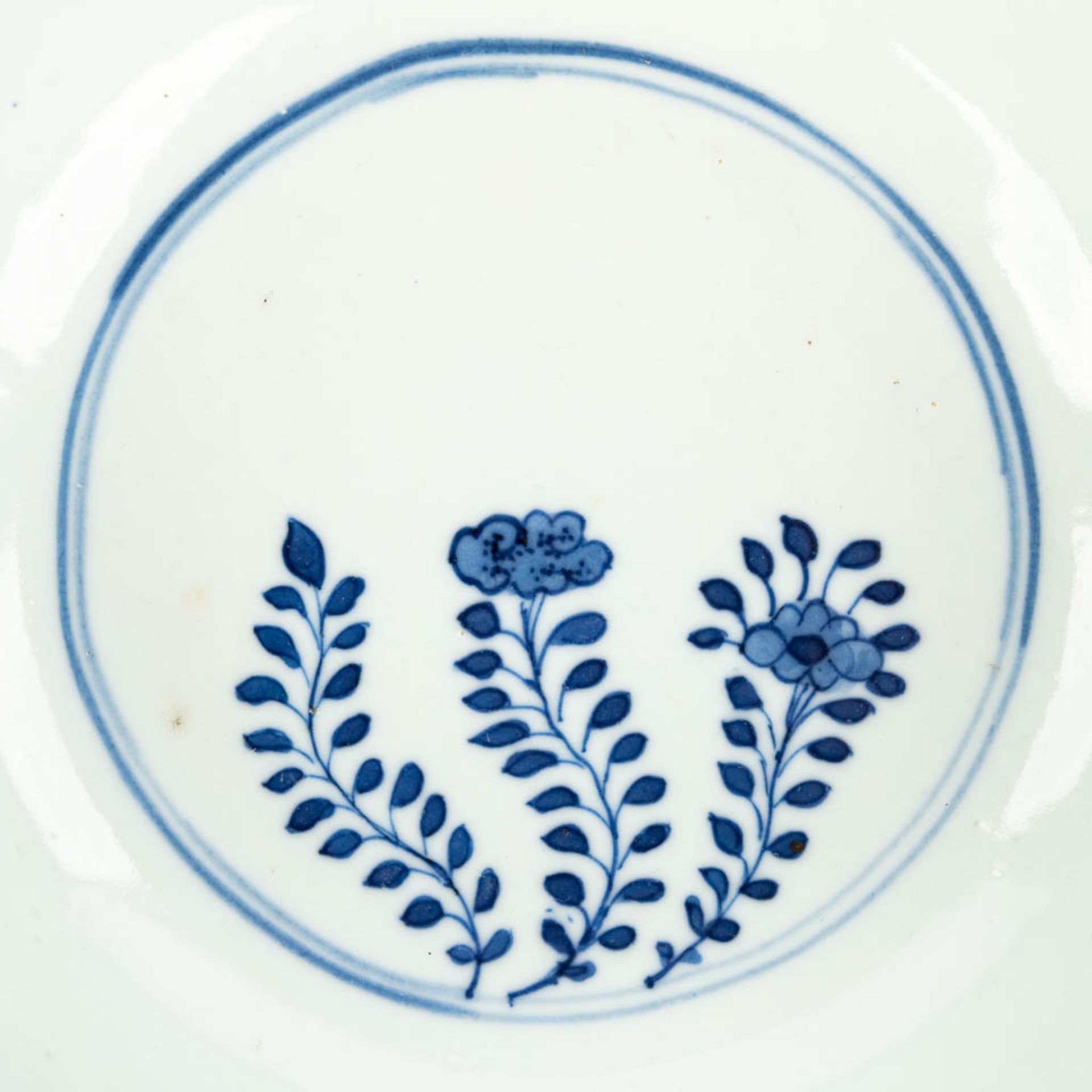 A pair of Chinese bowls made of porcelain with blue-white flower decor and marked Kangxi. (H:7,2cm) - Image 13 of 13