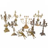 An assembled collection of brass and bronze and spelter candlesticks. (H:56cm)