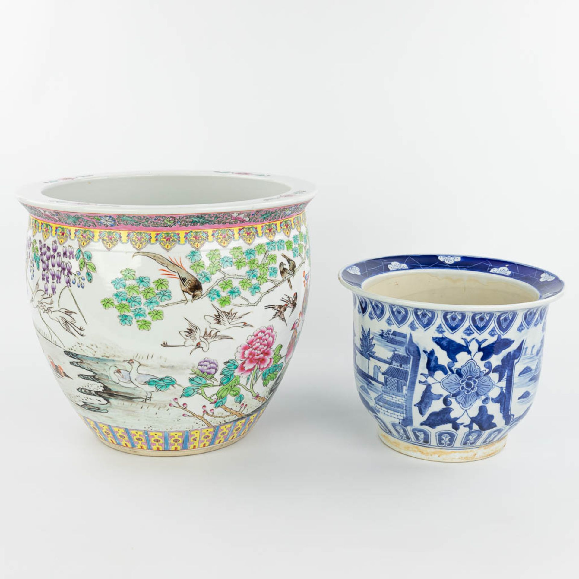 A set of 2 Chinese cache-pots made of porcelain of which 1 has a blue-white decor and the other a de - Image 3 of 15