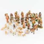 A large and extended Nativity scene with figurines and animals made of papier maché.