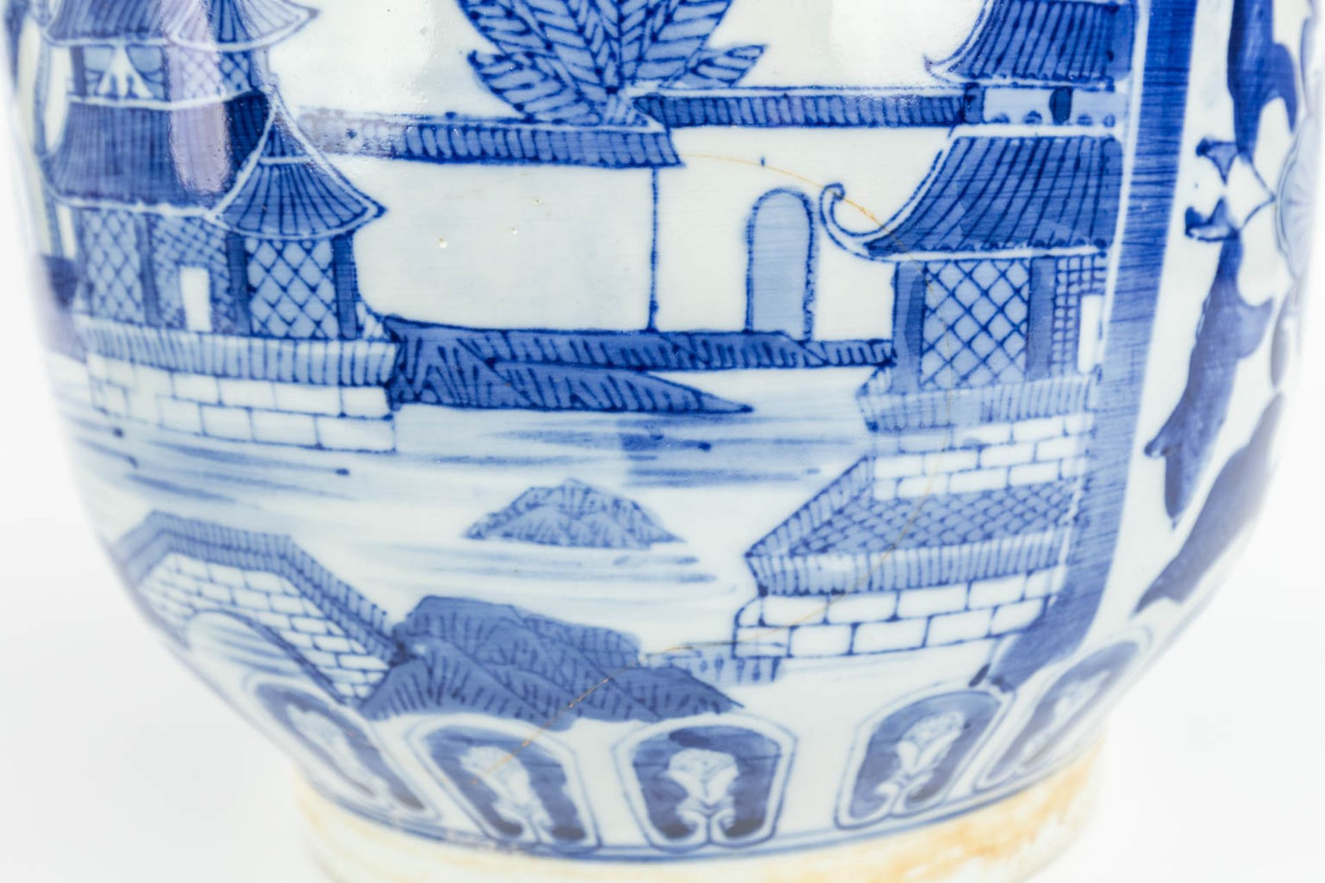 A set of 2 Chinese cache-pots made of porcelain of which 1 has a blue-white decor and the other a de - Image 10 of 15