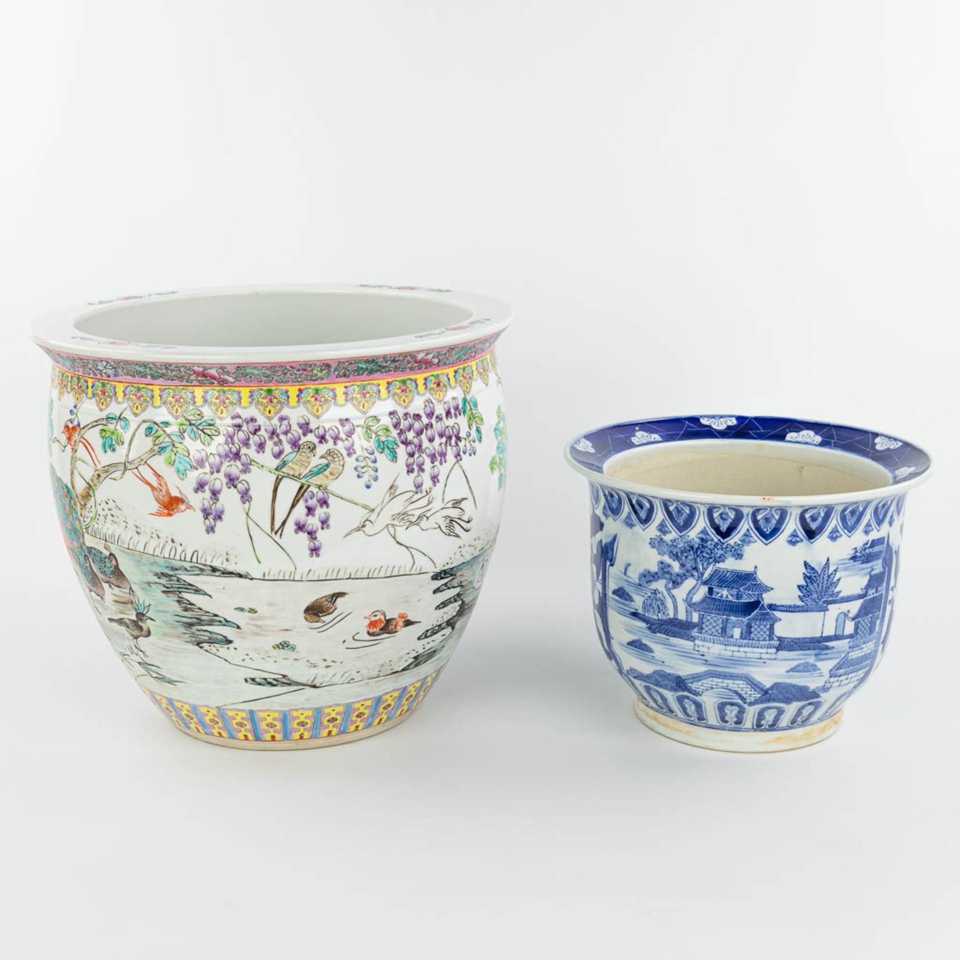 A set of 2 Chinese cache-pots made of porcelain of which 1 has a blue-white decor and the other a de - Image 8 of 15