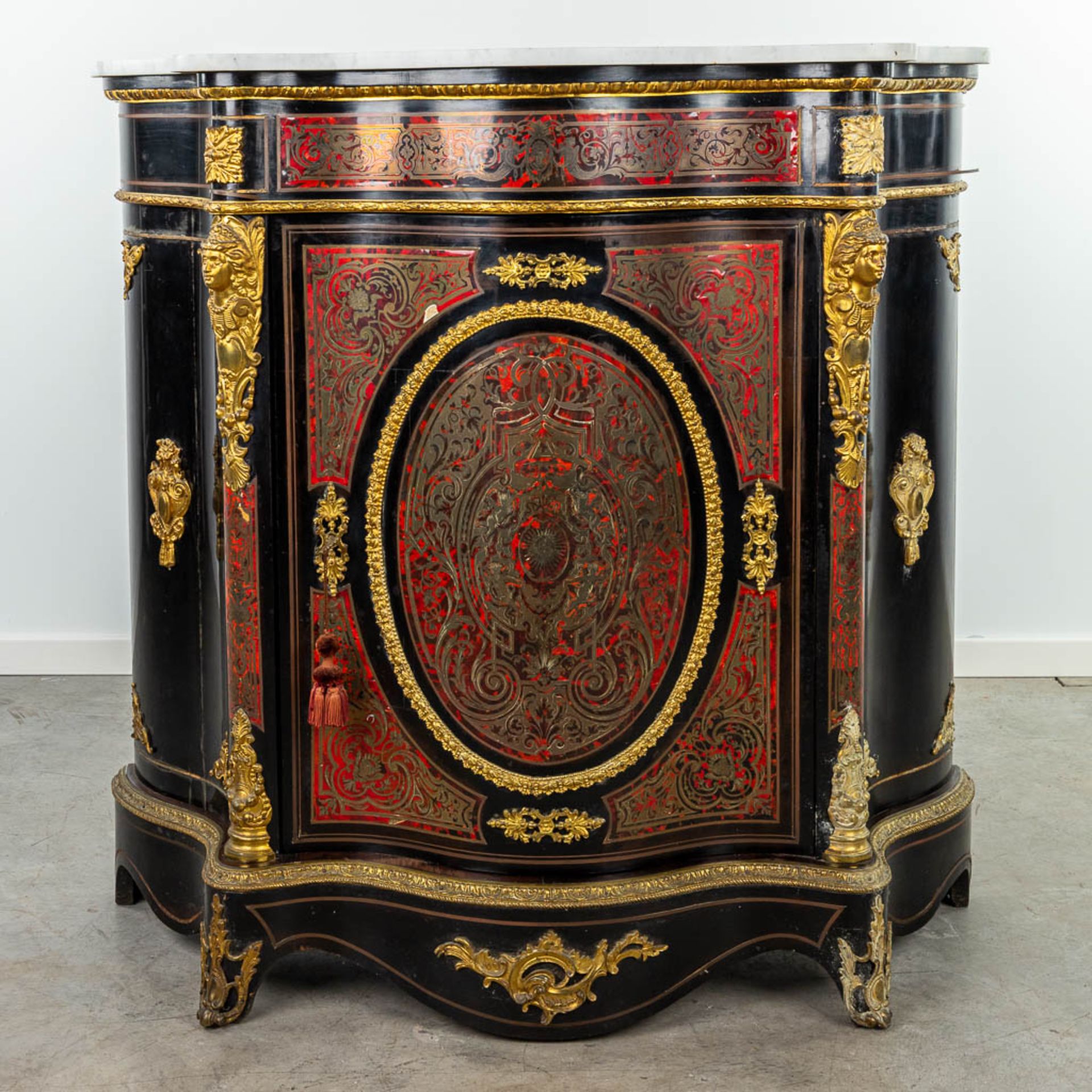 A cabinet with marble top made in Napoleon 3 style, mounted with bronze and finished with boulle tor