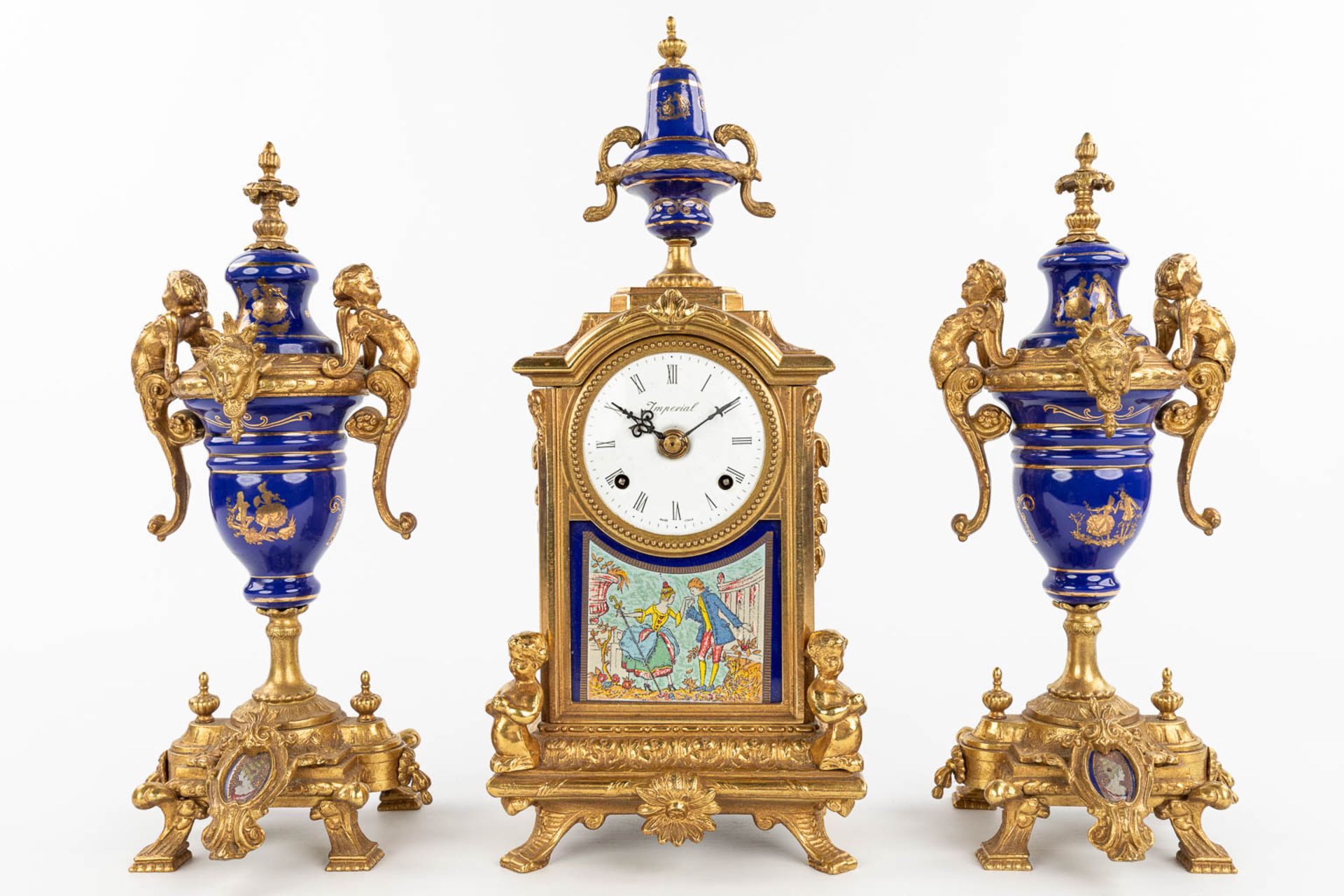 A three-piece mantle garniture clock made of bronze and porcelain and marked Imperial. (H:43cm) - Image 12 of 12