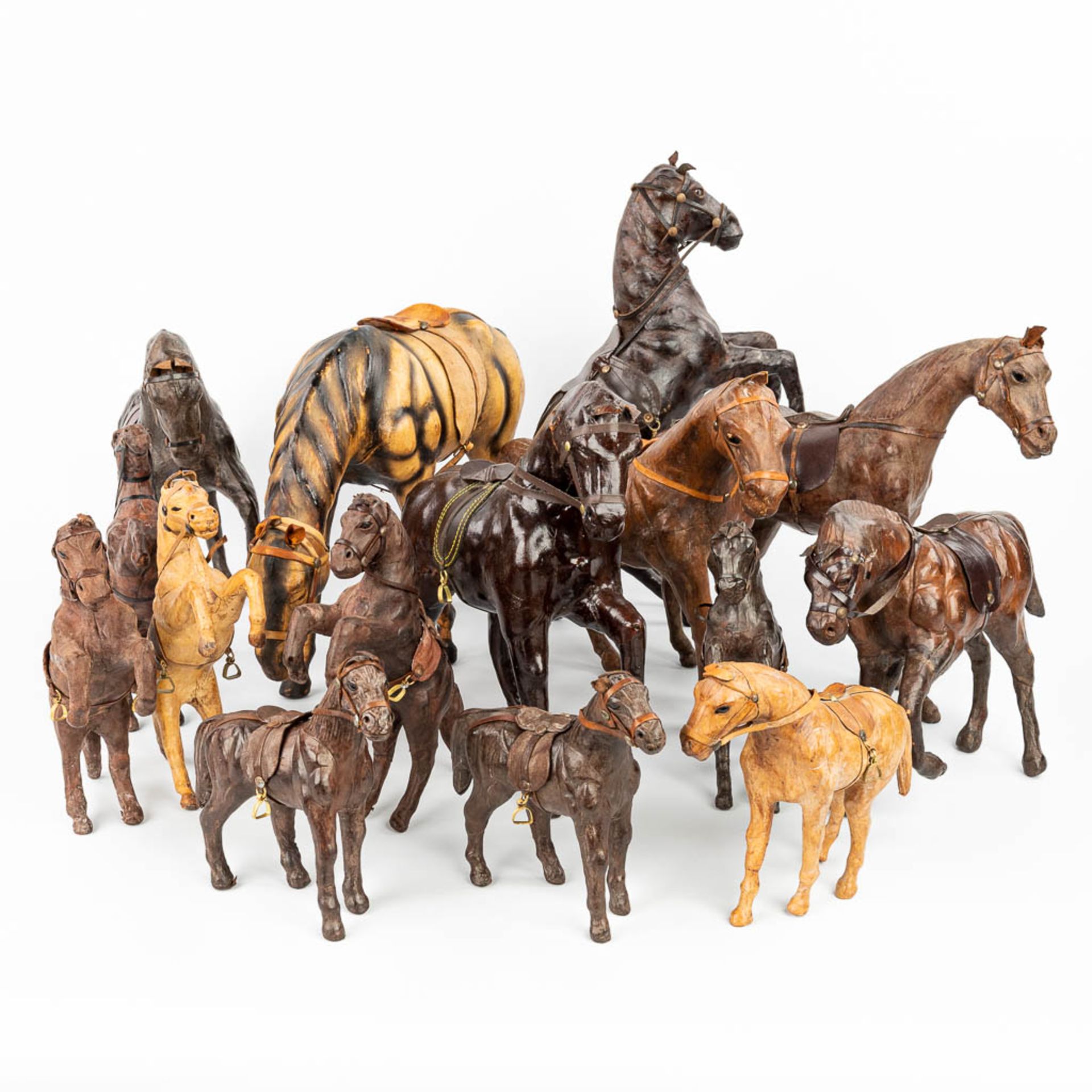 A collection of 15 horses made of Papier MachŽ and finished with leather. (H:30cm)
