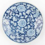 A large Chinese plate with blue-white floral decor.