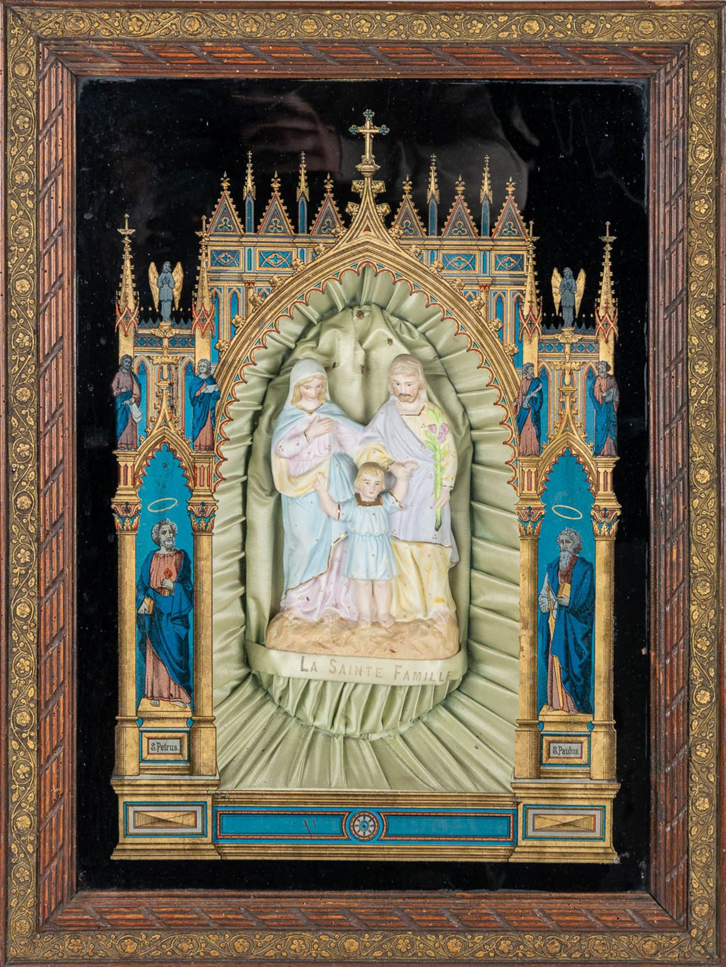 An Eglomisé reverse glass painting in gothic revival style, with a holy family statue made of bisque