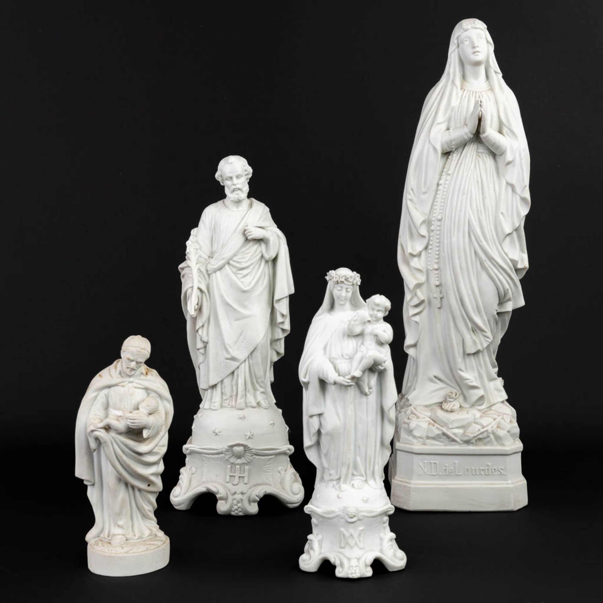 A collection of 4 biscuit porcelain statues of holy figurines. (H:52,5cm)