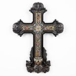 A crucifix finished with champleve, with a holy water font and mounted in an ebony cross. (H:43cm)