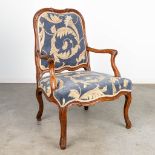 An armchair made in a Louis XV style and upholstered with fabric. Around 1800. (H:96cm)