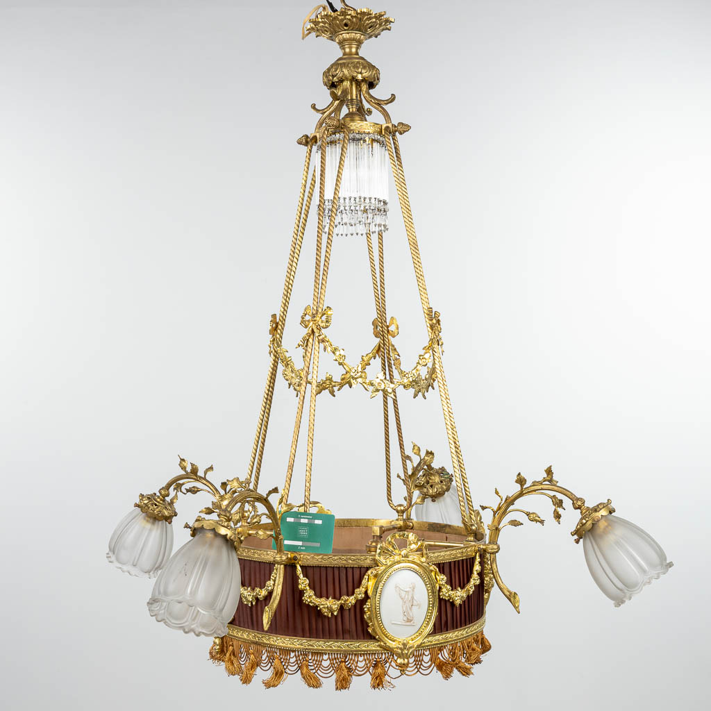 A chandelier made of bronze in Louis XVI style and finished with bisque plaques. (H:100cm) - Image 2 of 10