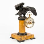 A pocket watch holder in the shape of an eagle mounted on a marble stand. (H:20,5cm)