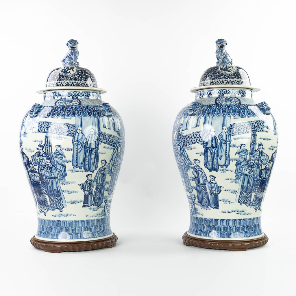 A pair of large Chinese vases with lid, made of blue-white porcelain with the emperor, dragons and w
