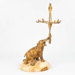 A table lamp 'Elephant figurine' made of gilt bronze with tusks, mounted on an onyx base and singed