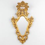 An antique mirror made of sculptured giltwood with stucco. (H:89cm)