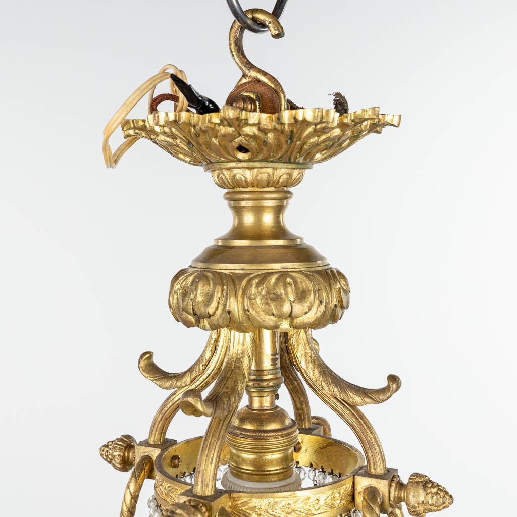 A chandelier made of bronze in Louis XVI style and finished with bisque plaques. (H:100cm) - Image 3 of 10