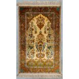 An oriental hand-made carpet made in Kashmir, India. (118 x 75 cm)