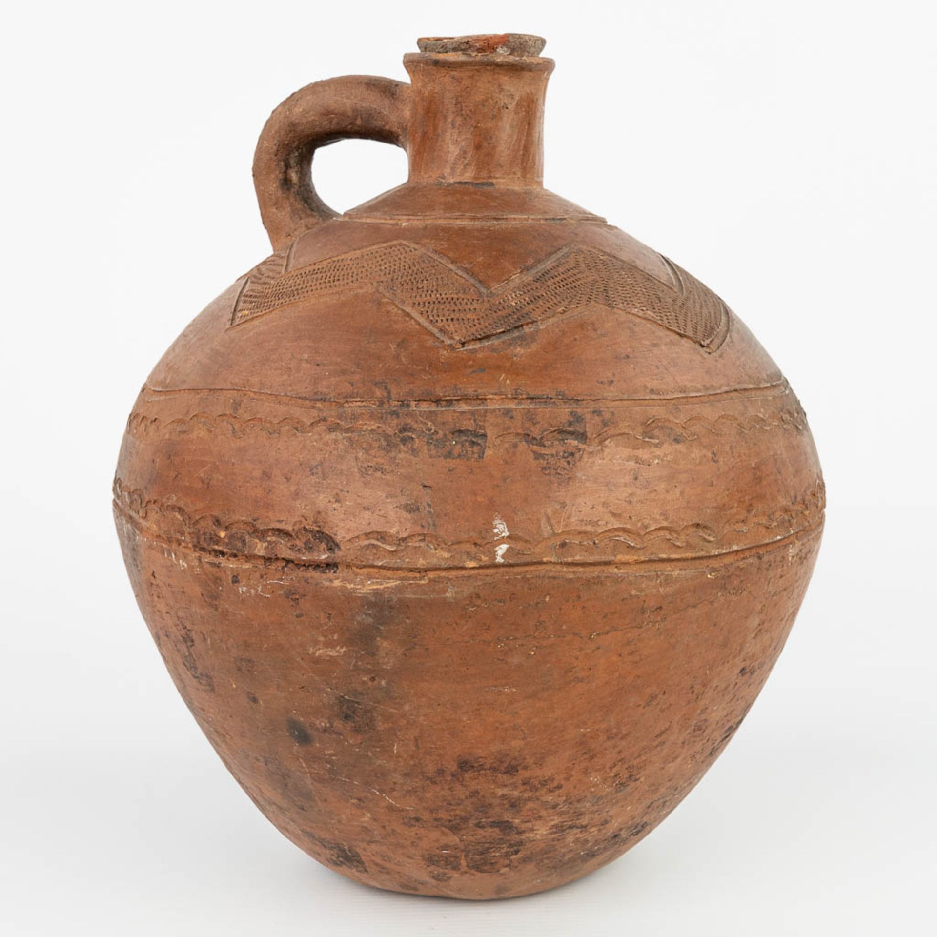 An antique jug with the original stopper made of terracotta finished with sgraffito decor. (H:32cm)