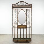 A coathanger and umbrella stand with mirror made of wrought iron and marked Victor Rabier. (H:208cm)