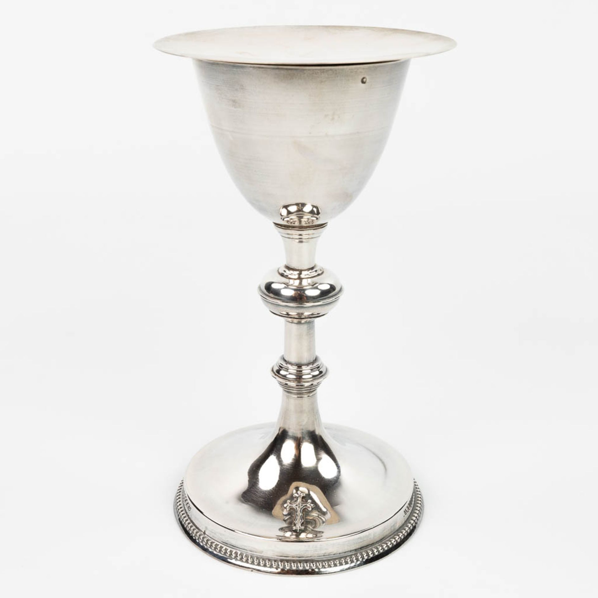 A French gothic revival silver chalice, with a paten and spoon. (H:21cm)