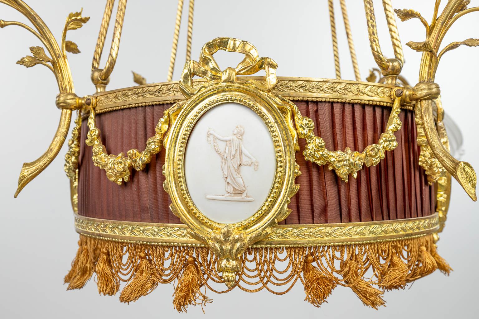 A chandelier made of bronze in Louis XVI style and finished with bisque plaques. (H:100cm) - Image 7 of 10