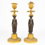 A pair of caryatid candlesticks, made of patinated and ormolu bronze during the empire period, early