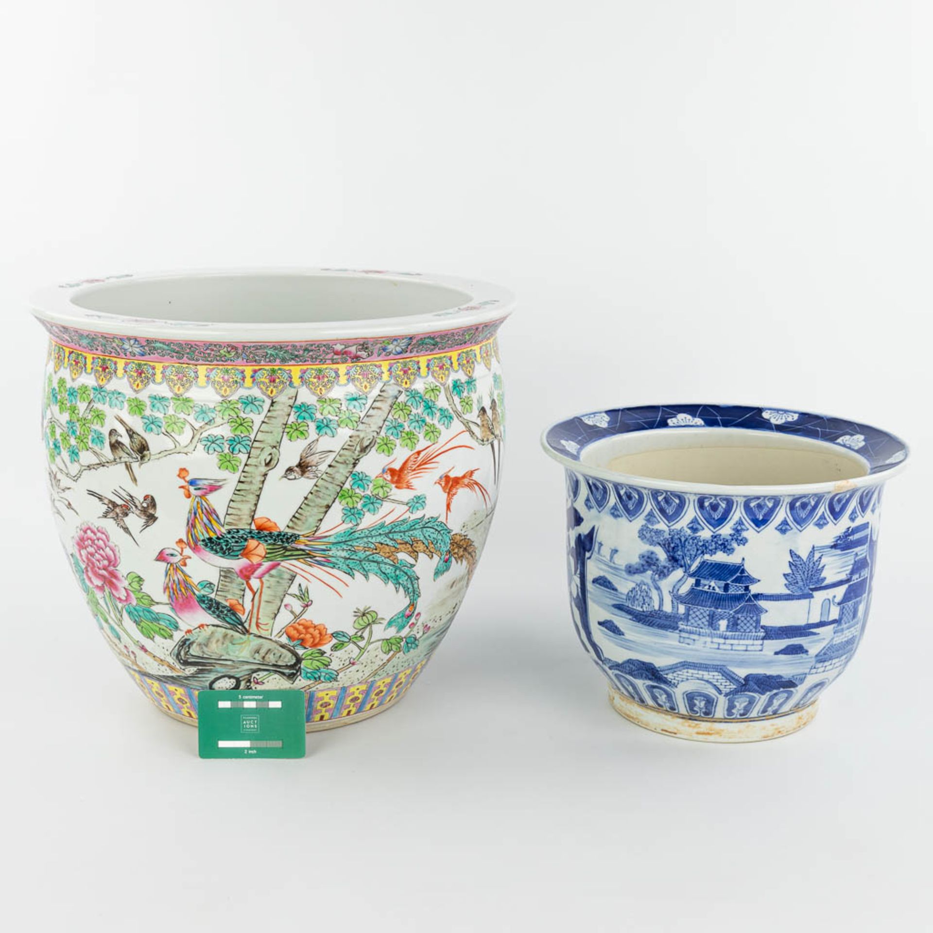 A set of 2 Chinese cache-pots made of porcelain of which 1 has a blue-white decor and the other a de - Image 6 of 15