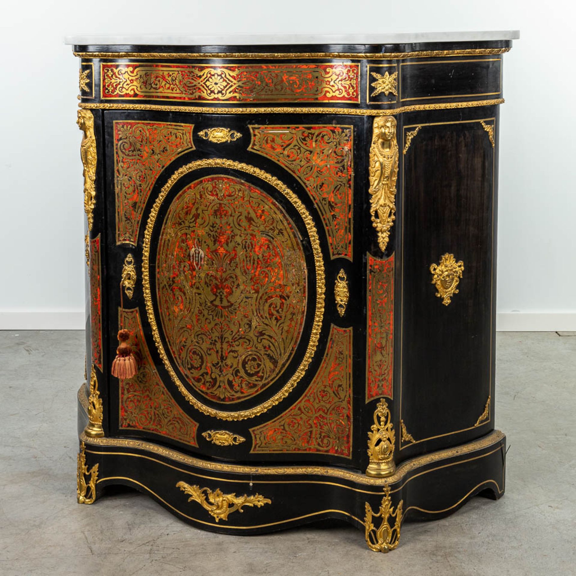 A cabinet with marble top made in Napoleon 3 style, mounted with bronze and finished with boulle tor
