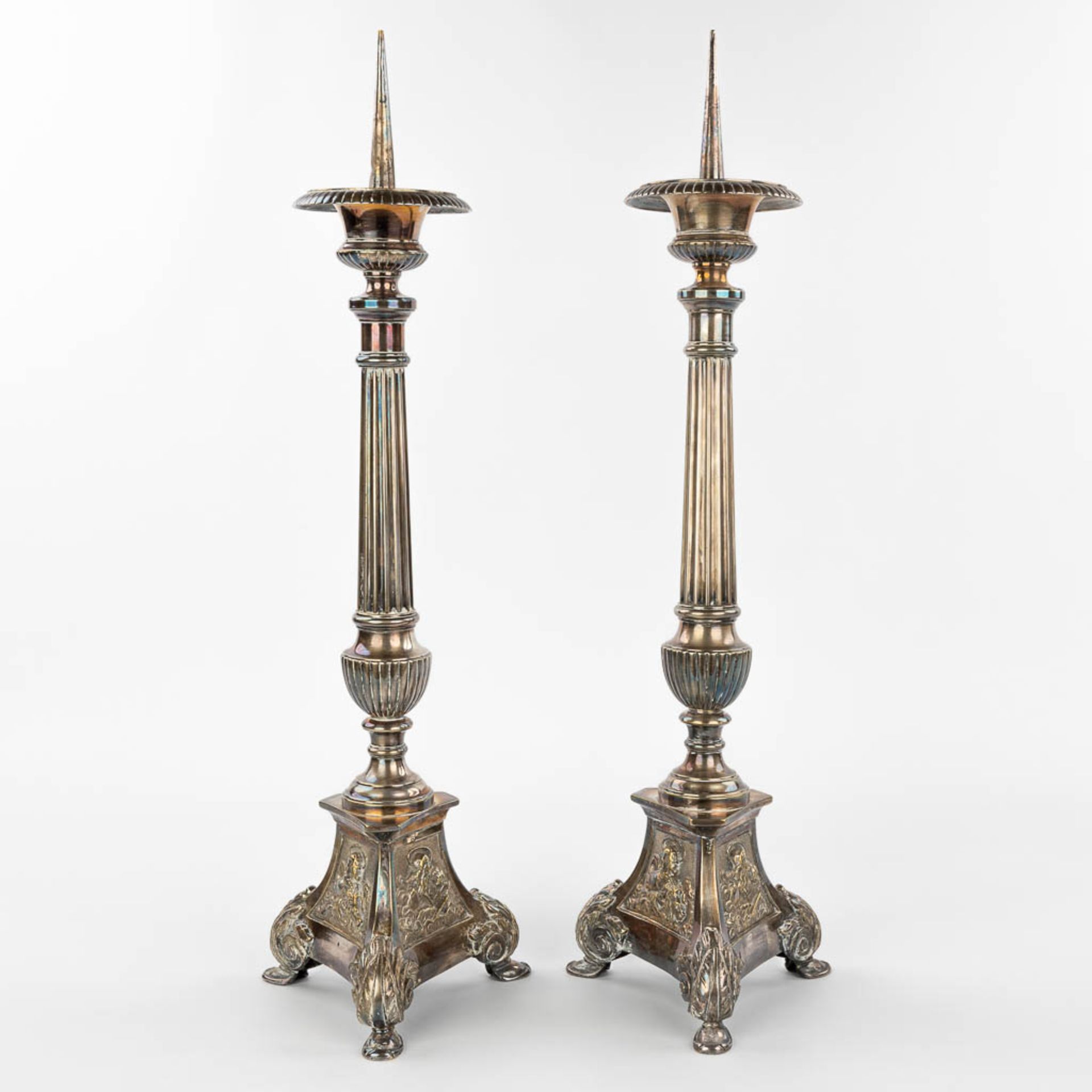 A pair of silver-plated candlesticks decorated with images of holy figurines. (H:59cm)