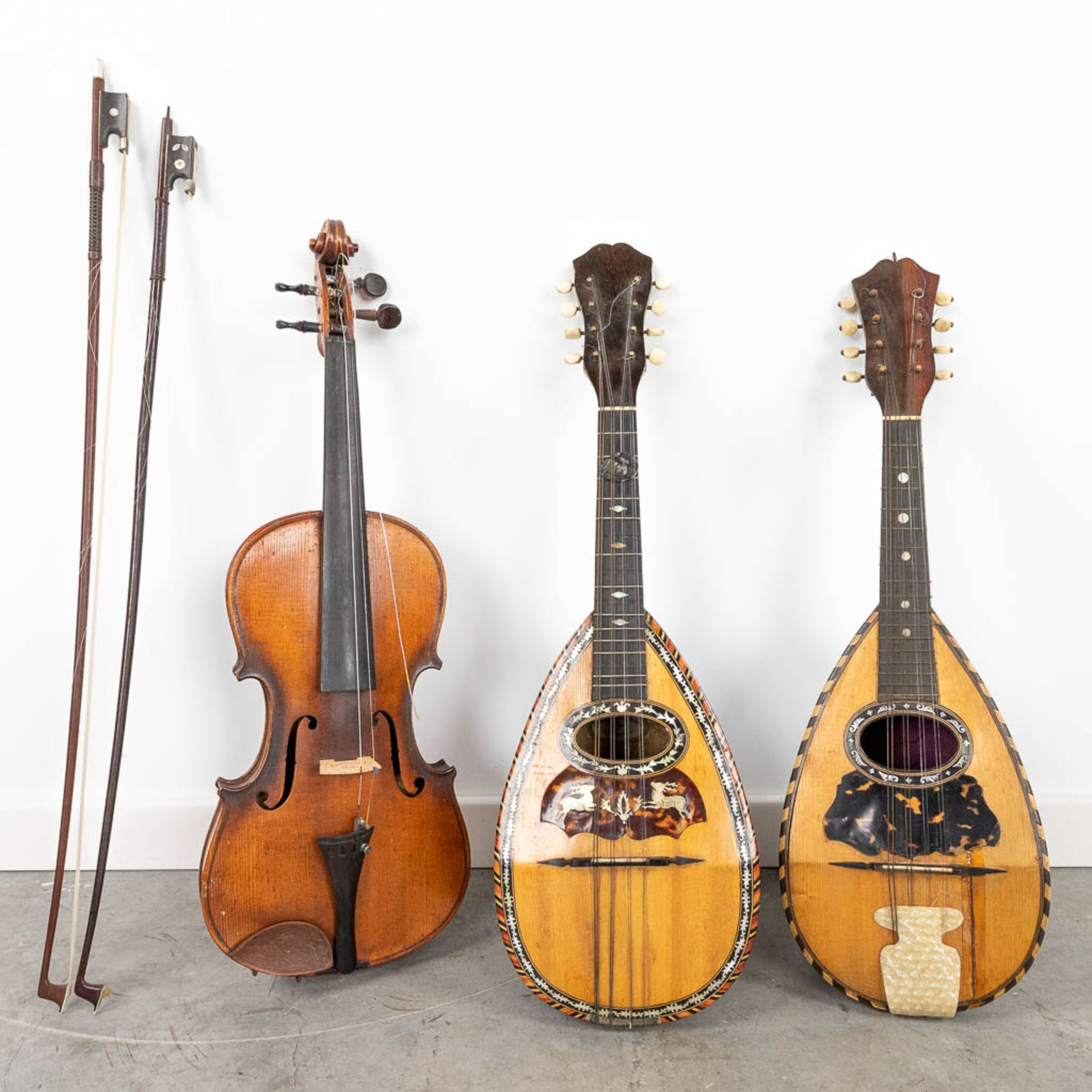 A collection of 3 musical instruments: 2 mandolines and a violin, after a model made by Stradivarius