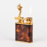 A gold-plated table lighter, decorated with tortoiseshell and marked Maxim. In working condition. (H