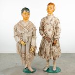 A pair of exceptional fitting dolls, with original clothing. (H:141cm)